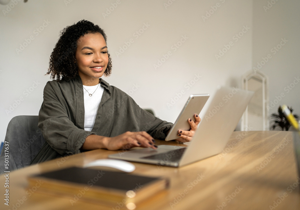 A female freelancer works for a company in an office coworking space, uses a laptop computer A female freelancer works for a company in an office coworking space, uses a laptop computer