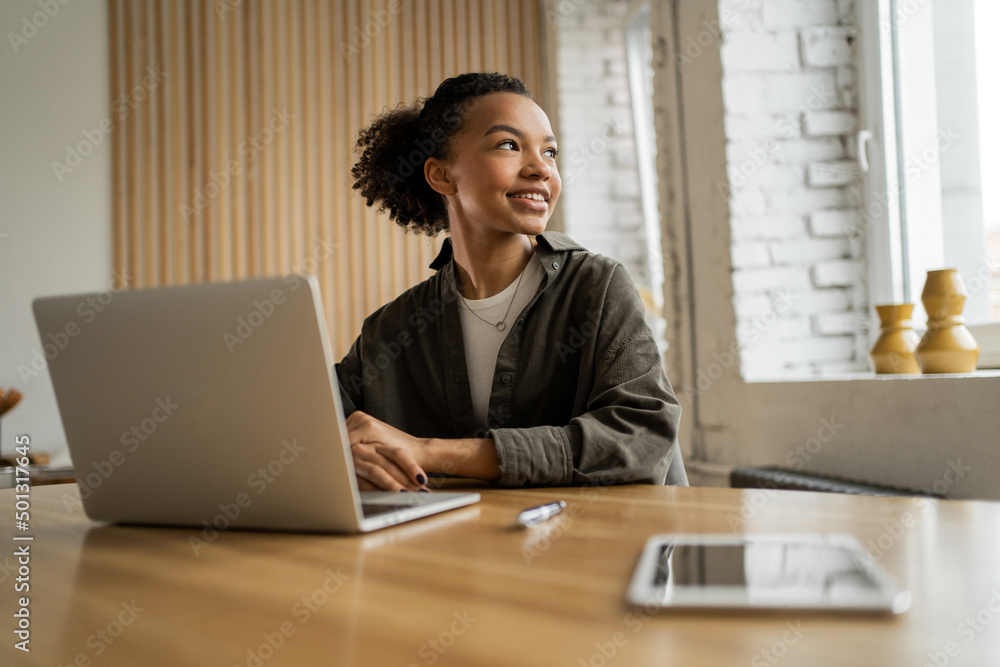 A female freelancer works in an office coworking space, uses a laptop computer A female freelancer works in an office coworking space, uses a laptop computer