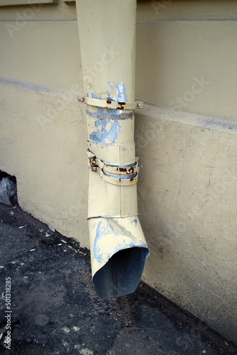 downspout of a building in the city in spring