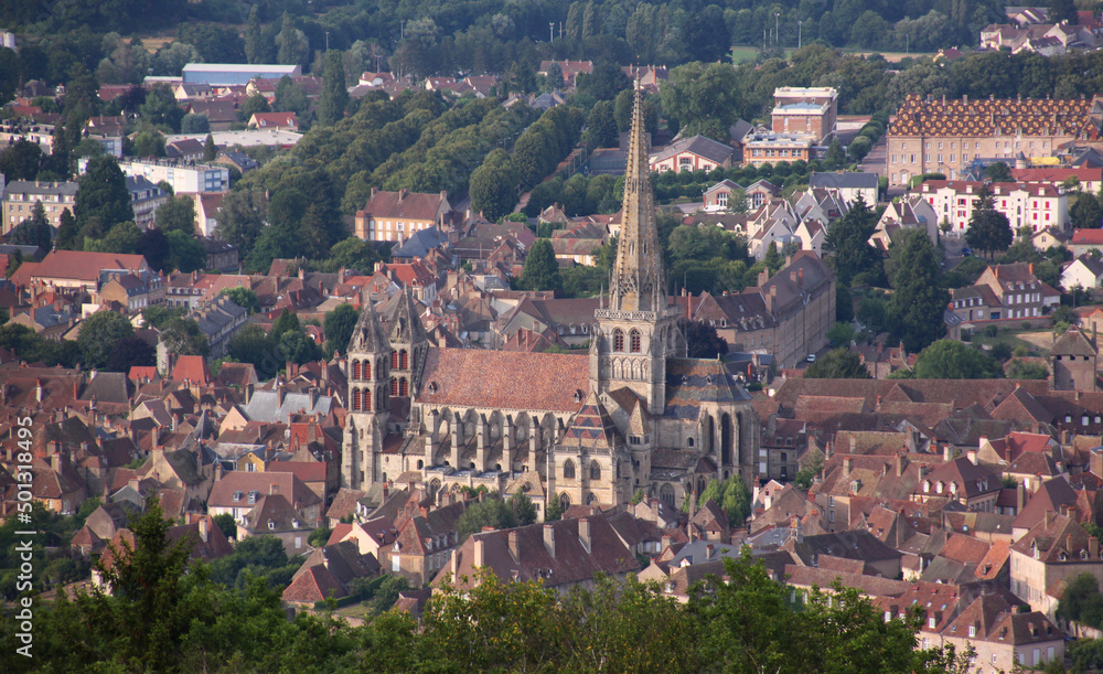 Gothic cathedral with its pointed steeple and red house roofs in the old town of Autun, Burgundy region in France