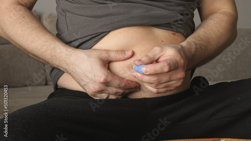 obese fat man injecting Semaglutide Ozempic injection control blood sugar levels