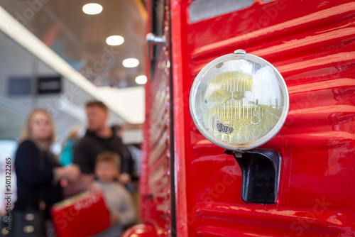 Close up of front left side of red retro vintage food van and headlamp at Ashford Outlet Centre, Apr 2022. photo