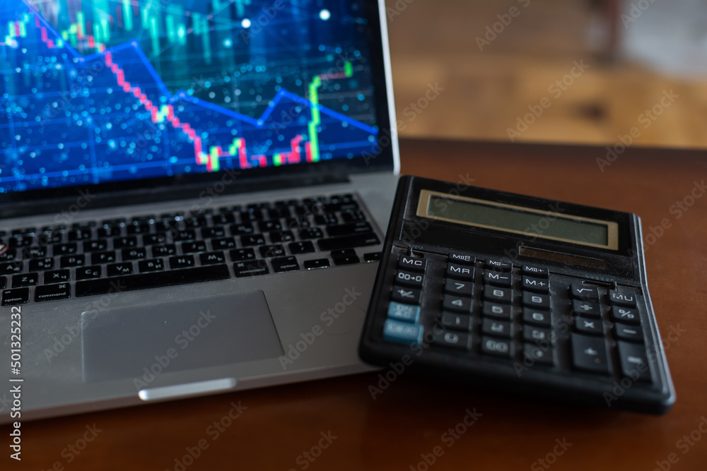 The report summarizes the results of business operations, laptop computer, calculator on desk of investor. top view. The report summarizes the results of business operations, laptop computer, calculator on desk of investor. top view.