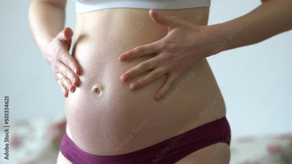 Pregnant woman skin care cream on a big belly, as expecting a child. Pregnant woman skin care cream on a big belly, as expecting a child.