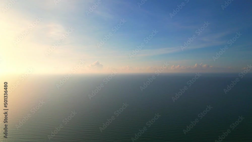 4K drone flying over the sea, sunset on the horizon. The orange and yellow light reflected in the beautiful sea waves. tropical sea in thailand
4K drone flying over the sea, sunset on the horizon. The orange and yellow light reflected in the beautiful sea waves. tropical sea in thailand