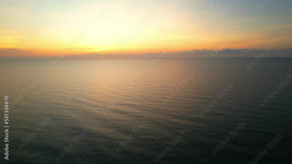 Aerial view from a drone, waves in the orange sea Sunset from the beautiful horizon. 4K
