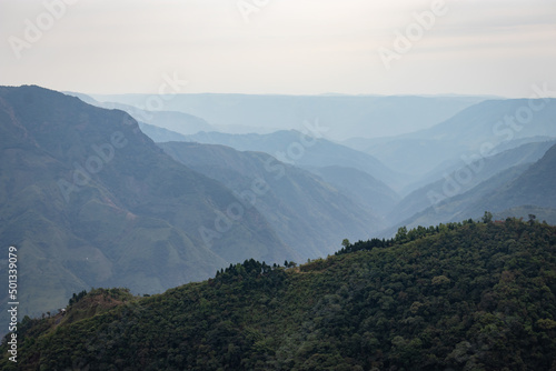 mountain valley covered with white mists and haze at morning from flat angle