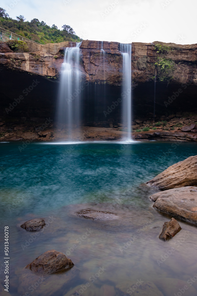 Naklejka premium waterfall streams falling from mountain top at morning long exposure shot from different angle