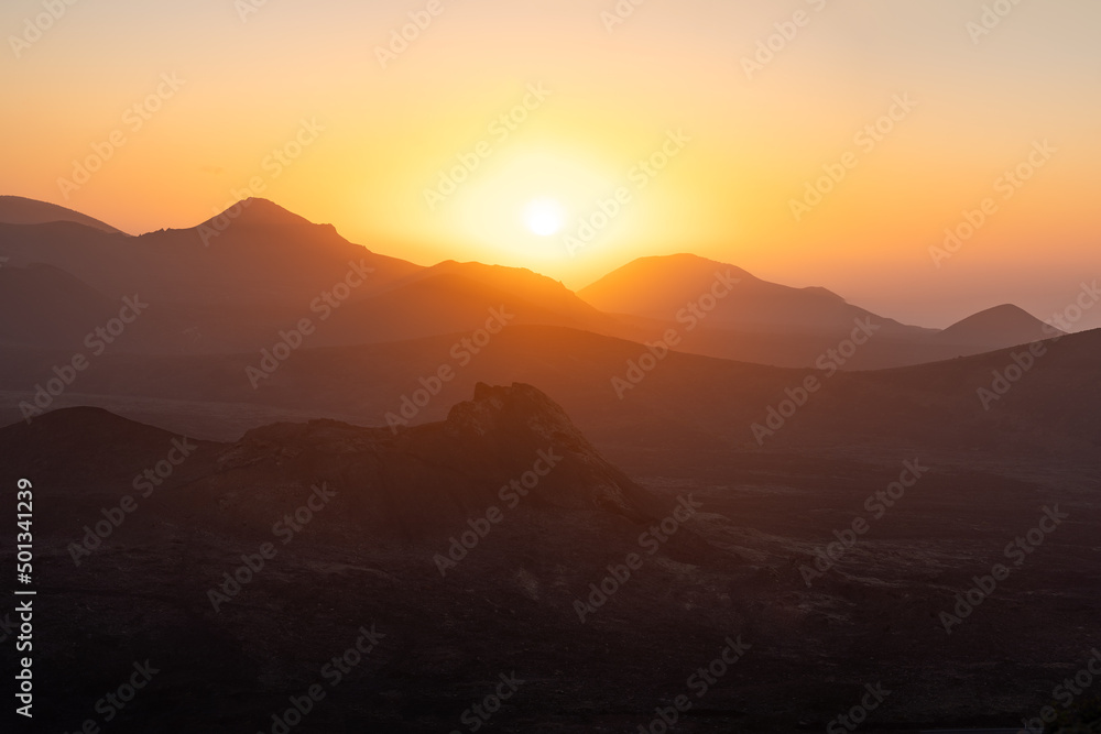 Sunset behind volcanos of the timanfaya national park on Lanzarote