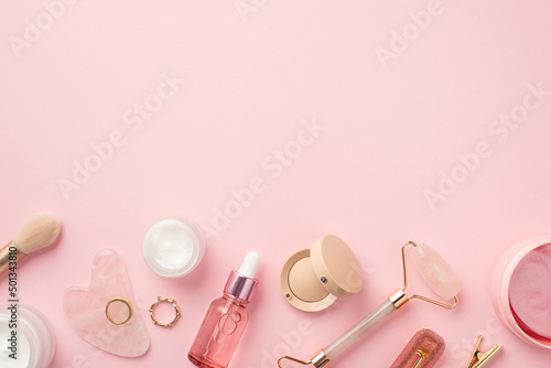 Fotobehang Top view photo of makeup brush rose quartz roller gua sha pink eye patches glass