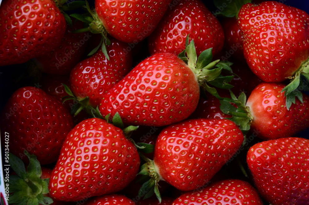Strawberry closeup background, flat lay, selective focus, macro. Top view of strawberries. Texture top view of fresh strawberries. Strawberry closeup background, flat lay, selective focus, macro. Top view of strawberries. Texture top view of fresh strawberries.