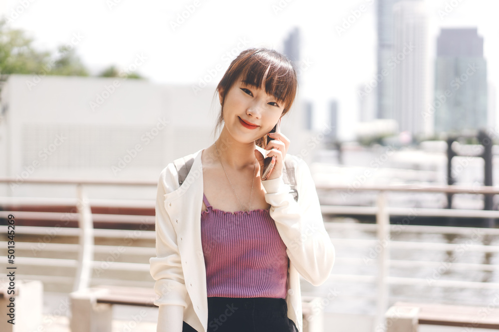 Young adult asian student college university woman calling by mobile phone