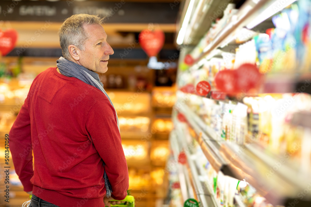 Back view of elderly man shopping alone at store