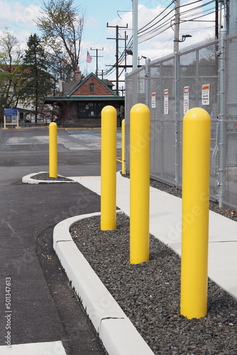 The yellow safety poles prevent cars from driving into the electrical wiring.