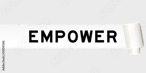 Ripped gray paper background that have word empower under torn part
