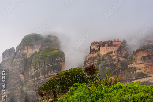 Meteora in Greece, monastery on the background of mountains, cloudy sky © ArturSniezhyn