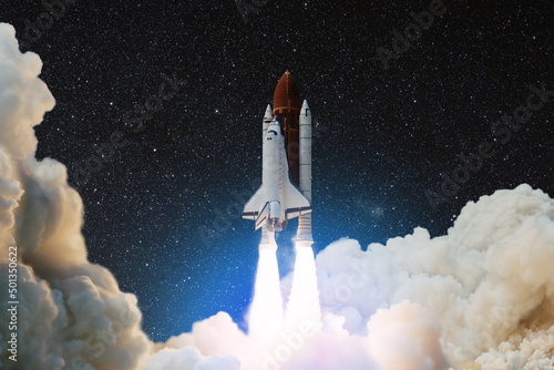 Spaceship lift off. Space shuttle with smoke and blast takes off into the starry sky. Rocket starts into space. Concept. Elements of this image furnished by NASA.