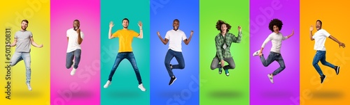 Carefree millennial guys of different races jumping up