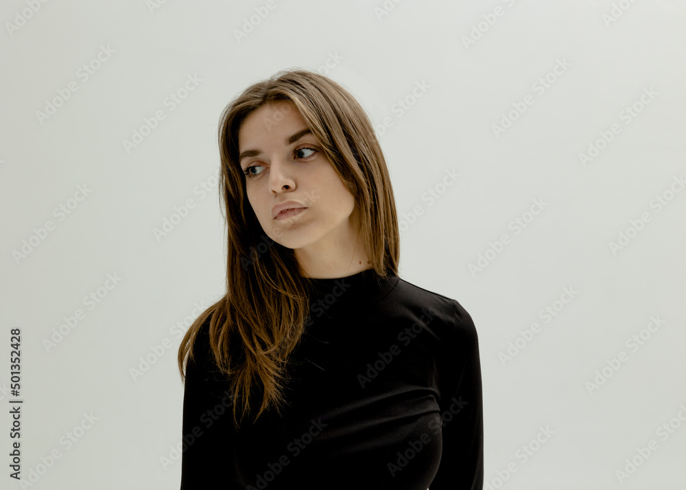 horizontal portrait of a sad woman in a black turtleneck on a light background horizontal portrait of a sad woman in a black turtleneck on a light background