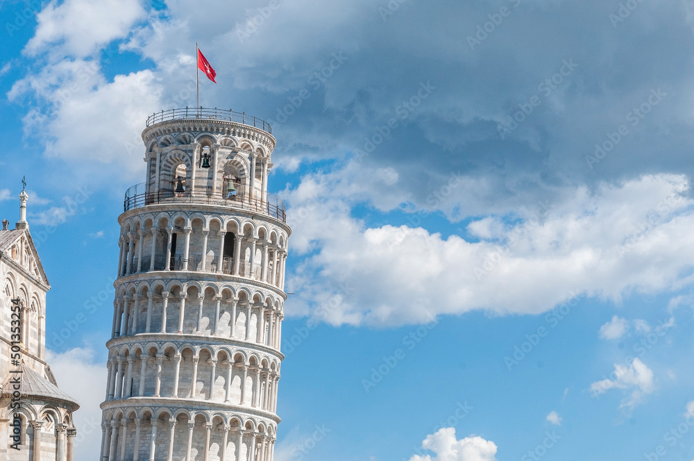 Pisa tower, detail of the peak under a cloudy sky