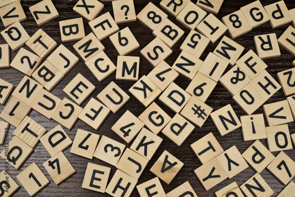 Wooden tiles with latin alphabet letters and characters, brown background Wooden tiles with latin alphabet letters and characters, brown background