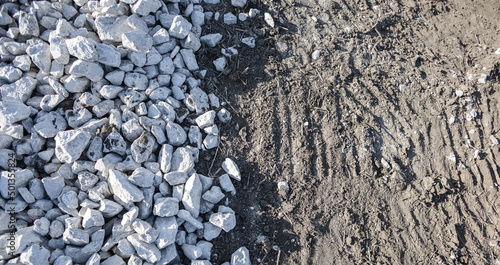 Wallpaper Mural Top view, pile of white and gray stone on the soil ground with natural sunlight. Abstract two tone of small rocks pattern. Mix element for new building foundation at construction site. Rough texture. Torontodigital.ca