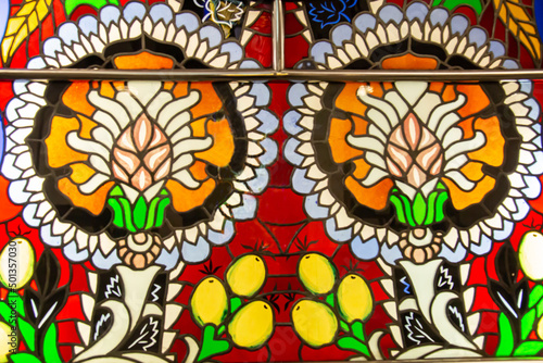 The stained glass window is bright and beautiful in the form of two flowers with lemons of yellow red orange color. World tourism flowers .