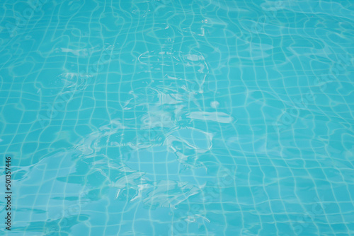 Swimming pool floor with water ripple. Blue texture background.