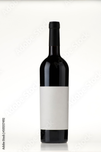 red wine bottle with blank label on isolated white background