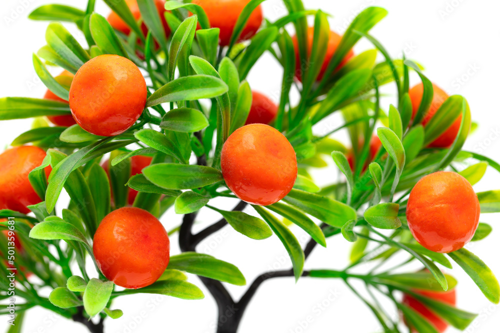 Artificial mandarin fruits on a white