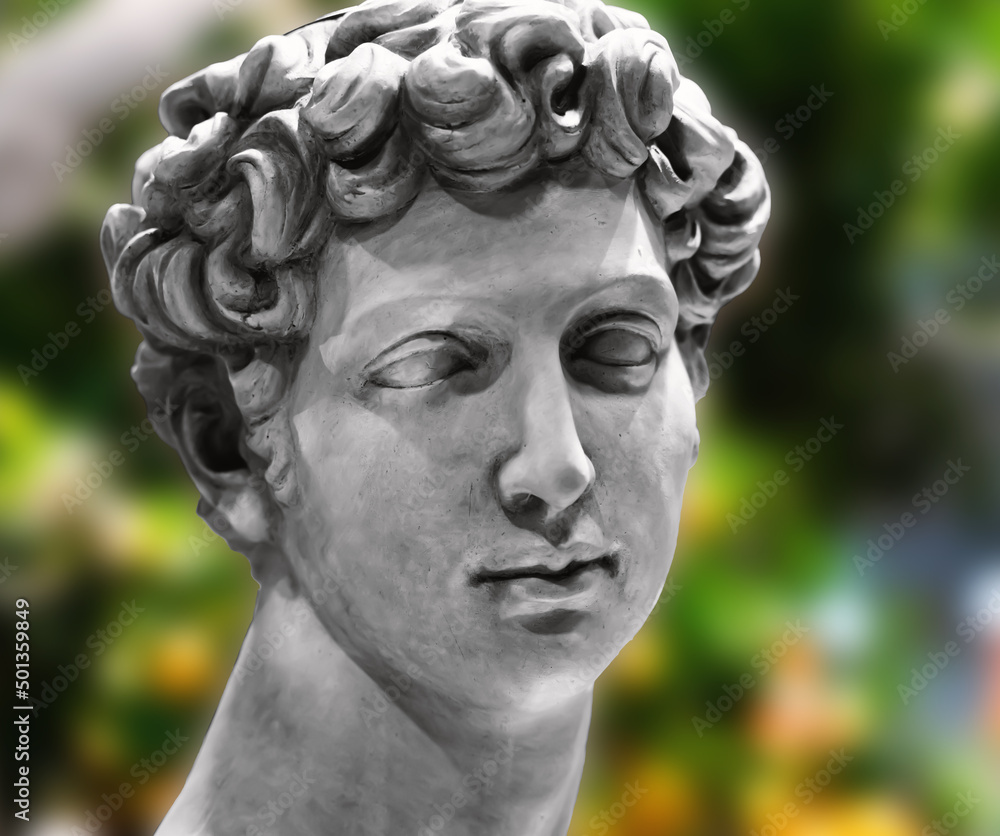 Renaissance sculpture or statue of a male head isolated on black background. Renaissance sculpture or statue of a male head isolated on black background.