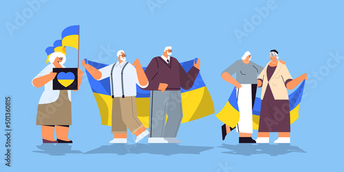 senior people protesters holding Ukrainian flags pray for Ukraine peace save Ukraine from russia stop war concept