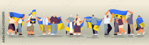people protesters holding Ukrainian flags pray for Ukraine peace save Ukraine from russia stop war concept