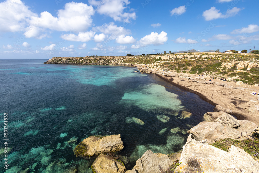 Calcarenite quarries at Cala Azzurra beach. Characteristic limestone landscape of the sea coast of Favignana, (Egadi) Aegadian Islands, Trapani, Sicily, Italy Calcarenite quarries at Cala Azzurra beach. Characteristic limestone landscape of the sea coast of Favignana, (Egadi) Aegadian Islands, Trapani, Sicily, Italy