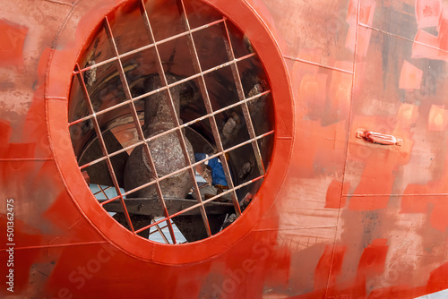 Close up view of a ship yard worker inside big ship thruster tunnel inspecting bow thruster photo
