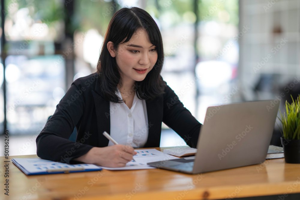 Asian business women using notebook and smiling happy for working in modern room, Business concept Asian business women using notebook and smiling happy for working in modern room, Business concept