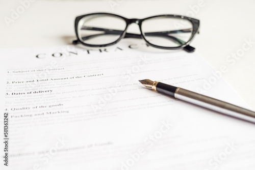 Close up of a job application form on desk with pen and glasses