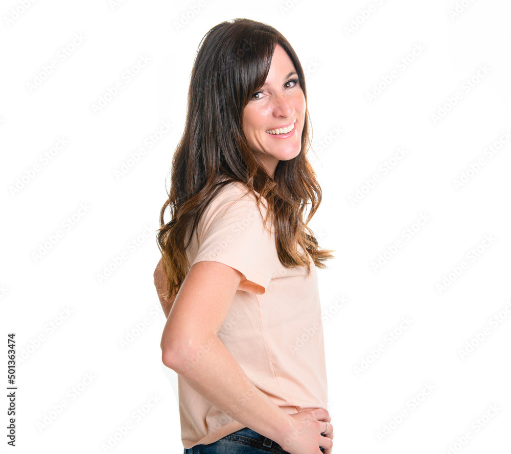 Happy carefree woman with joyful expression, smiling while standing in relaxed pose against white background Happy carefree woman with joyful expression, smiling while standing in relaxed pose against white background