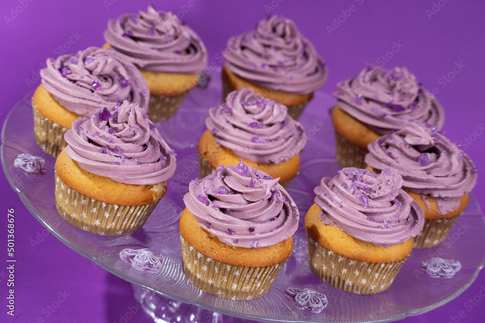 Cupcakes with violet scented swiss meringue buttercream decorated with pieces of violet candy
