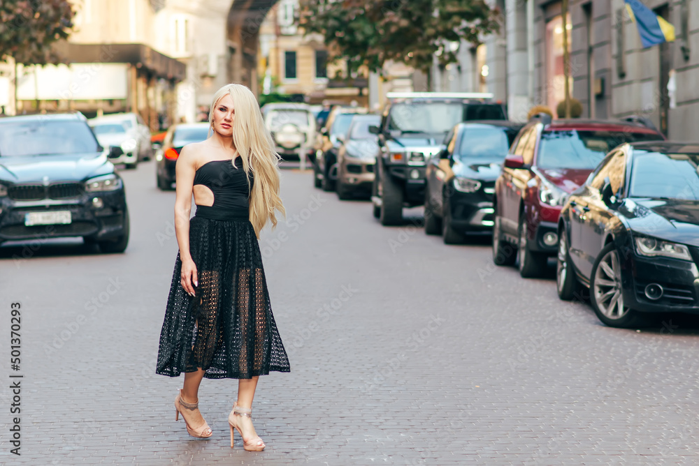 fashion outdoor portrait of beautiful blond girl on street.
