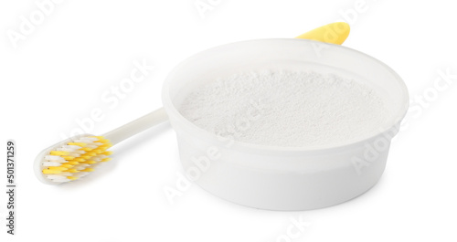 Bowl of tooth powder and brush on white background