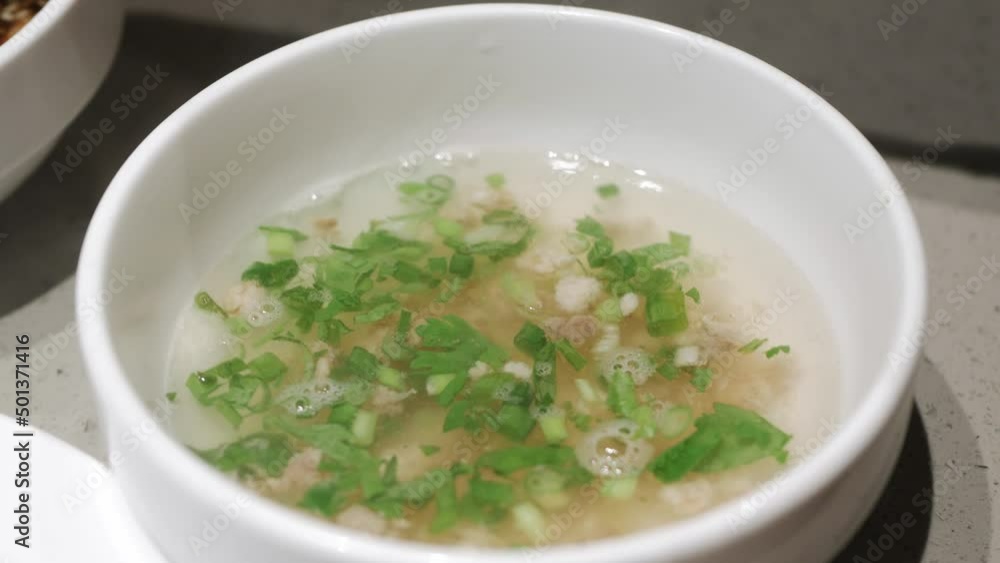 pouring hot soup into white soup bowl. Sichuan hotpot style pouring hot soup into white soup bowl. Sichuan hotpot style