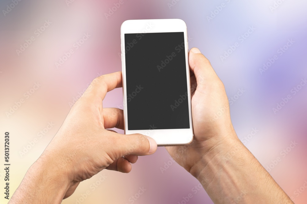 Hand holds phone Sample social media app interface on mobile phone showing shared video content Hand holds phone Sample social media app interface on mobile phone showing shared video content