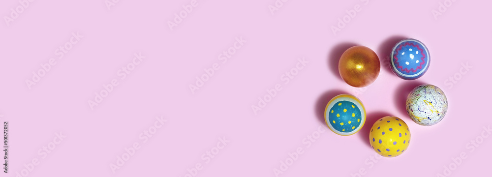 Banner. Colorful Easter eggs on pink background. Eggs on A Paper background. Multicolored egg for Happy easter. Hello spring and Happy Easter holiday concept. Top View