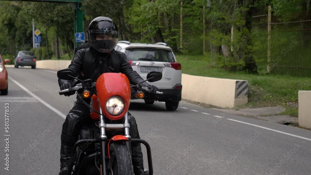 Motorcycle rider in the city traffic Motorcycle rider in the city traffic