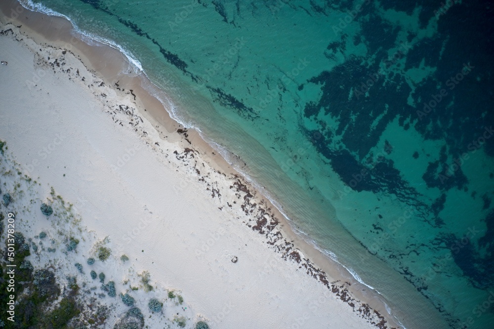 Drone field of view of of footprints in the sand and water from above beach  in Western Australia.