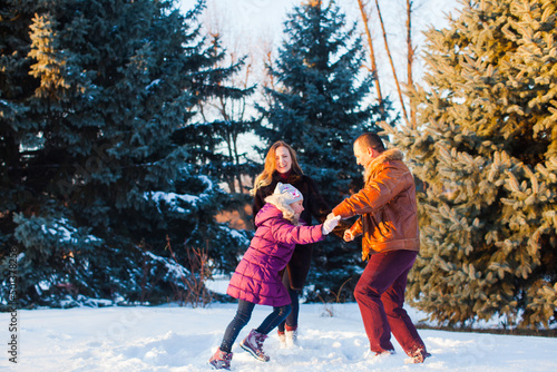 The happy family having fun outdoors in winter