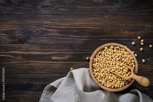 Soy is a source of plant based protein. Vegan food. Soya beans in the wooden bowl. Top view with copy space.