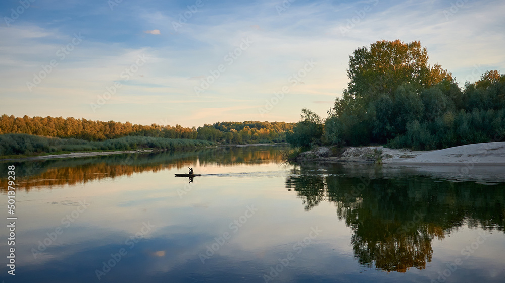 man sails on a boat on the Desna river in Chernihiv, Ukraine