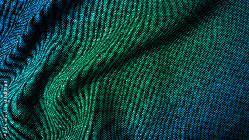 close up texture of creased fabric. gradient in green and blue color tone, woolen fabric. wavy cloth background showing fiber detail. gradient drapery background with beautiful, light and shadow. close up texture of creased fabric. gradient in green and blue color tone, woolen fabric. wavy cloth background showing fiber detail. gradient drapery background with beautiful, light and shadow.